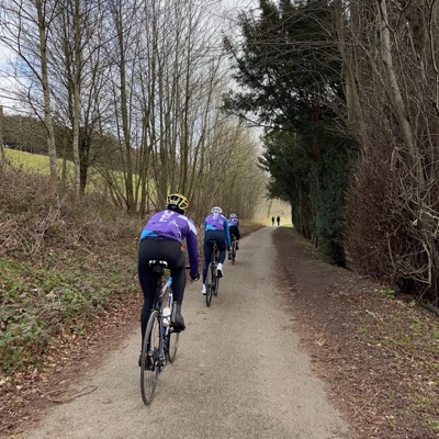 Three cyclists in Celsius Cycling University College London kit riding along a paved path