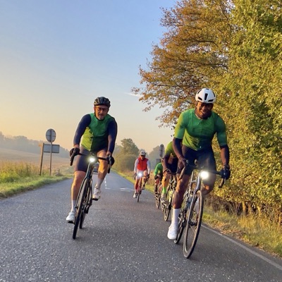Dawn Raid Velo riders in the green kit riding at sunrise